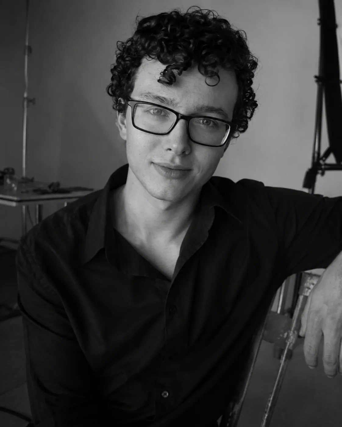 Black-and-white portrait of Matthew Mashford, seated, looking into the camera